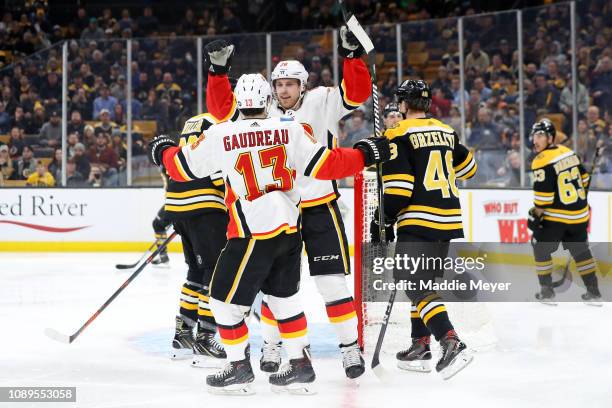 Elias Lindholm celebrates with Johnny Gaudreau of the Calgary Flames after scoring a goal against the Boston Bruins during the second period at TD...