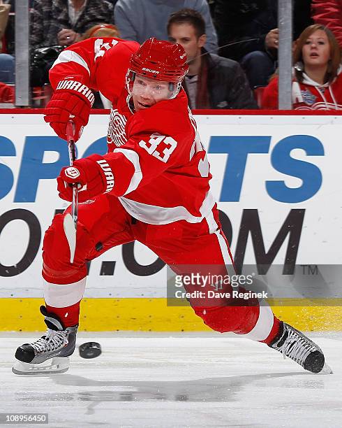 Kris Draper of the Detroit Red Wings takes a shot during an NHL game against the Nashville Predators at Joe Louis Arena on February 9, 2011 in...