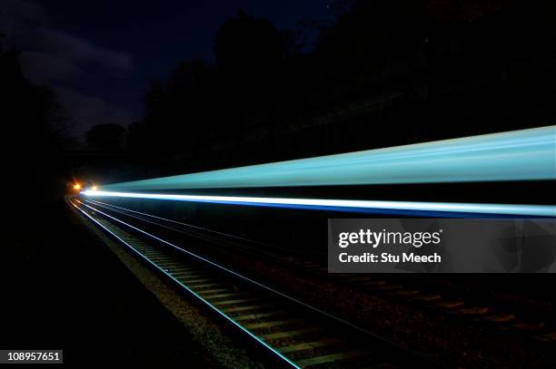 moving intercity train - long exposure train stock pictures, royalty-free photos & images