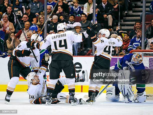 Brandon McMillan celebrates his second period goal with teammates Maxime Lapierre, Dan Sexton, and Cam Fowler of the Anaheim Ducks, while Cory...