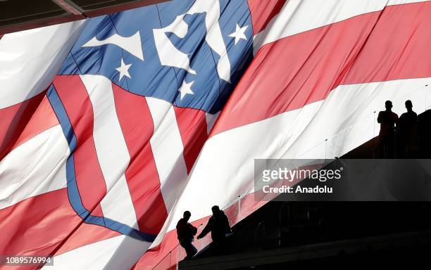 Silhouettes of Atletico Madrid's supporters are seen behind club's flag during a La Liga soccer match between Club Atletico de Madrid and Getafe CF...