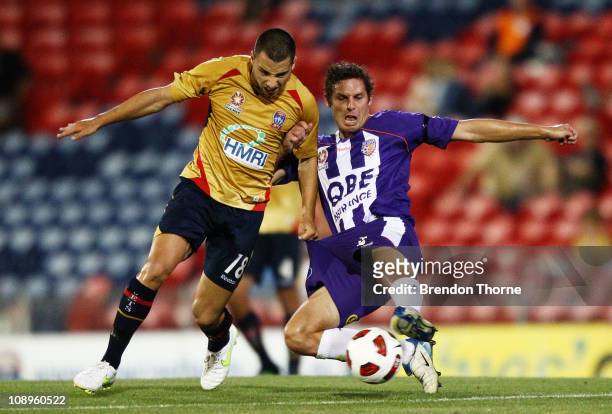 Marko Jesic of the Jets competes with Josh Mitchell of the Glory during the round 26 A-League match between the Newcastle Jets and the Perth Glory at...