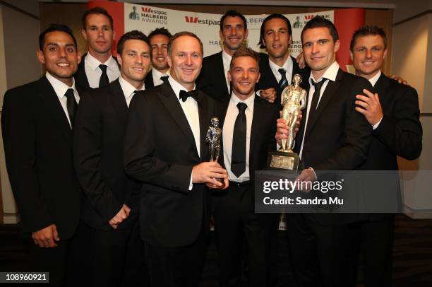 New Zealand Prime Minister John Key poses with the All Whites team after winning the supreme award during the Westpac Halberg Awards at the SkyCity...