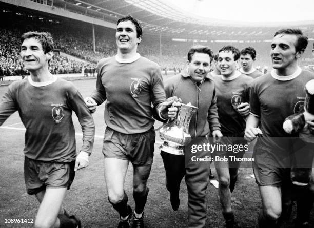 The Liverpool team, including, left to right, Geoff Strong, Ron Yeats, Gordon Milne, Ian Callaghan, Chris Lawler and Peter Thompson parade the trophy...