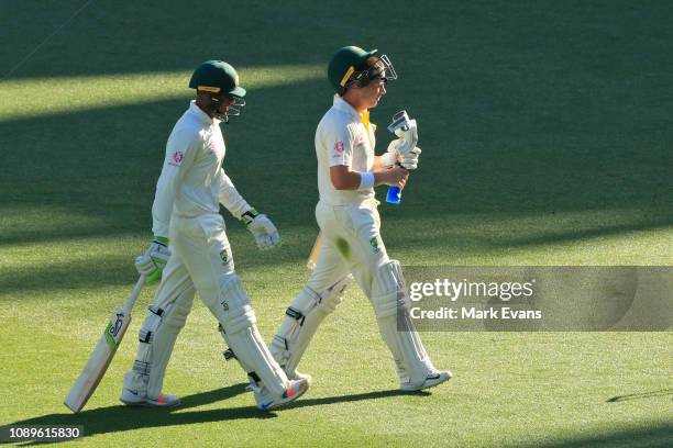 Usman Khawaja of Australia and Marcus Harris of Australia walk off at stumps during day two of the Fourth Test match in the series between Australia...