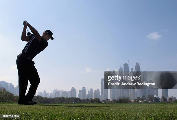 Tiger Woods of the USA hits his tee-shot on the eighth hole during the first round of the Omega Dubai Desert Classic on the Majlis course at the...