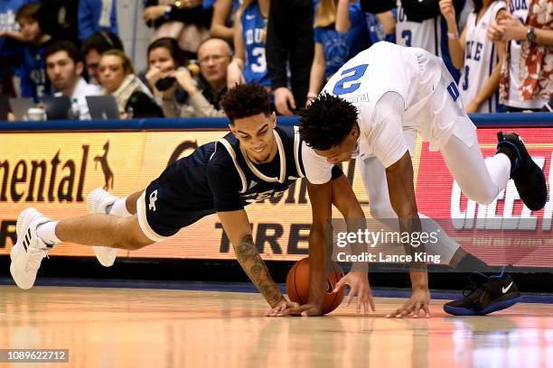 Michael Devoe of the Georgia Tech Yellow Jackets and Cam Reddish of the Duke Blue Devils battle for a loose ball in the first half at Cameron Indoor...