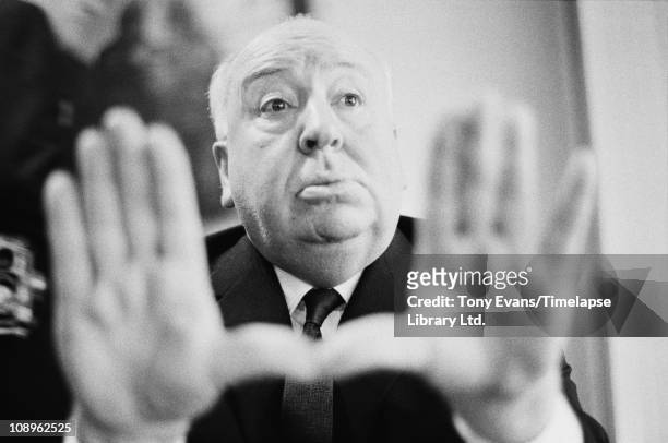 English film director and producer Alfred Hitchcock frames a shot with his hands, 1964.