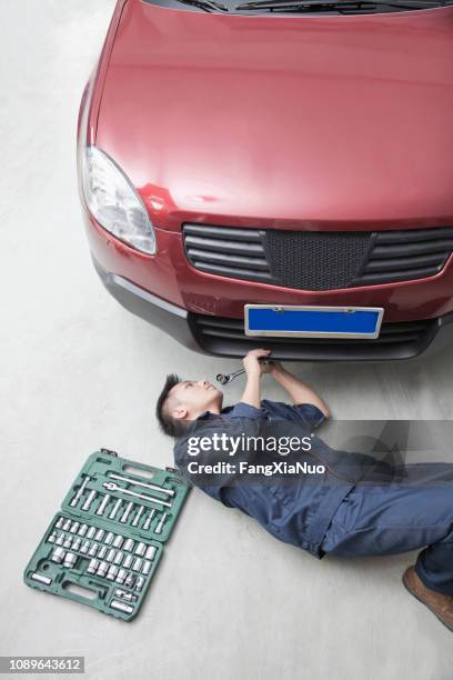 chinese mechanic working in garage - engine under hood stock pictures, royalty-free photos & images