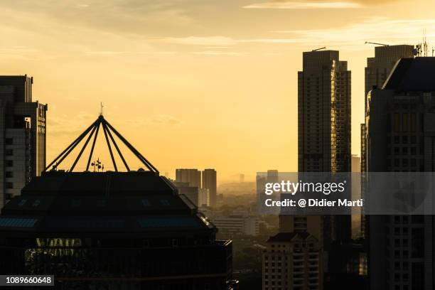 sunset over jakarta business district in indonesia capital city. - newly industrialized country stock pictures, royalty-free photos & images