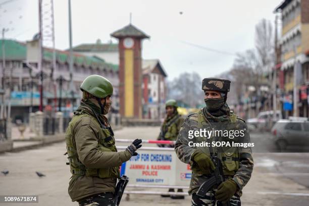 Indian army men seen standing guard on deserted streets of Srinagar during restrictions on the eve of India's 70th Republic day. Authorities imposed...