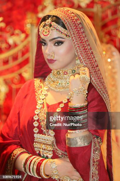 Indian model wearing an exquisite bridal lehenga with traditional opulent jewellery during the Lavish Dulhan bridal show in Toronto, Ontario, Canada....