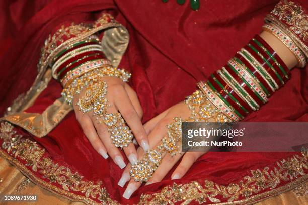 Close-up of the hands of a Indian model wearing an exquisite bridal lehenga with traditional opulent jewellery during the Lavish Dulhan bridal show...