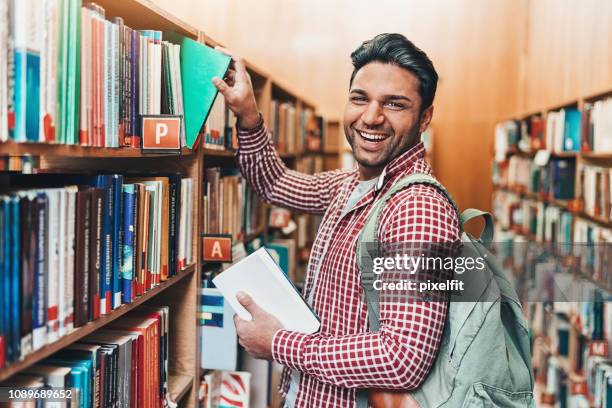 Reaching Books 636 Reaching For Book In Library Stock Photos, High-Res Pictures, and ...