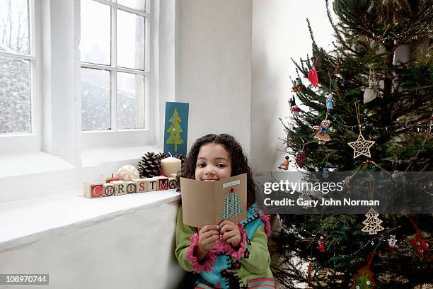 girl reading christmas card - receiving card stock pictures, royalty-free photos & images