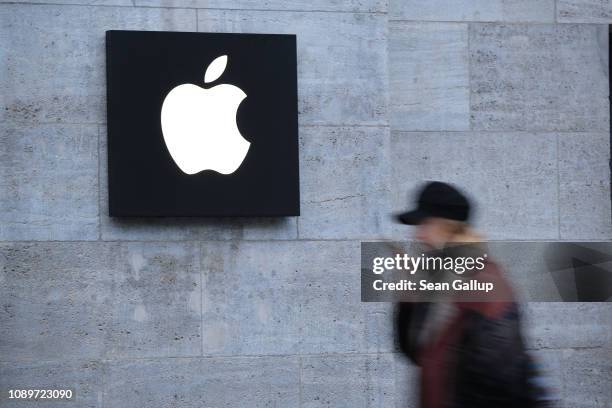 Woman holding a smartphone walks past the Apple Store on January 04, 2019 in Berlin, Germany. Apple has temporarily halted sales of its iPhone 7 and...