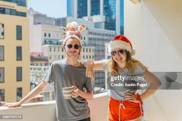 Teenage siblings in christmas hats