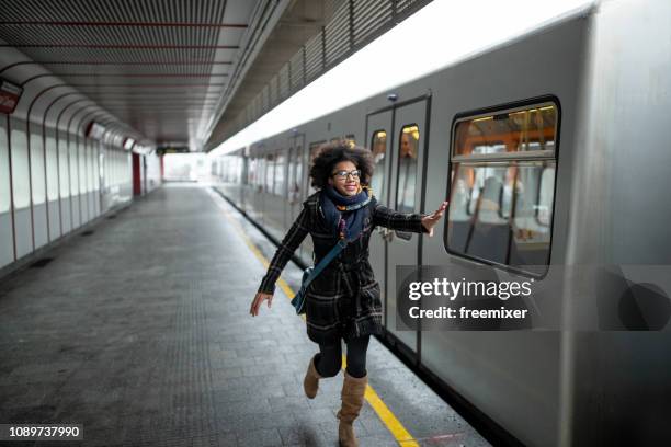 late for the train - woman catching stock pictures, royalty-free photos & images