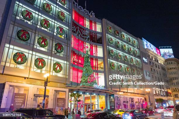 Night view of brightly illuminated facade of the flagship Macy's department store on Union Square in San Francisco, California on Christmas day,...