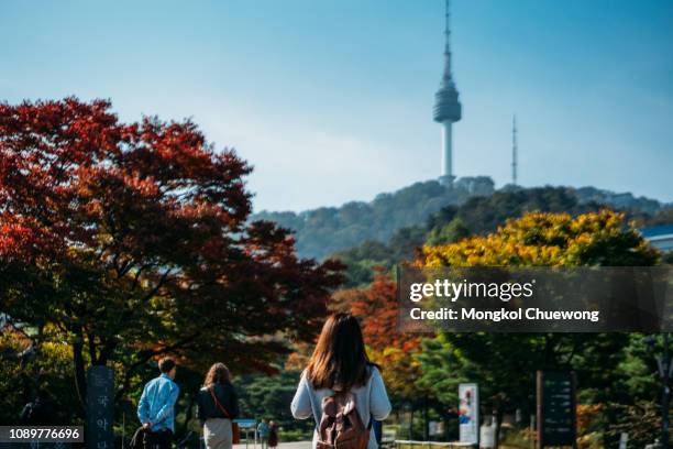 young woman traveler backpacker traveling into n seoul tower at namsan mountain in seoul city, south korea. - namsan stock pictures, royalty-free photos & images