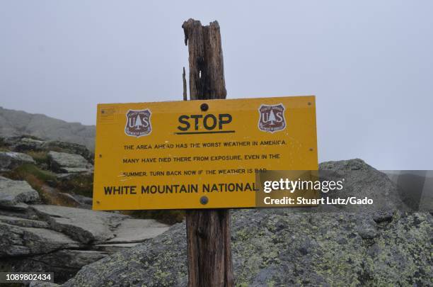 Warning sign on the Ammonoosuc Ravine Trail stating that the area has among the worst weather in America, and warnings hikers that many have died...