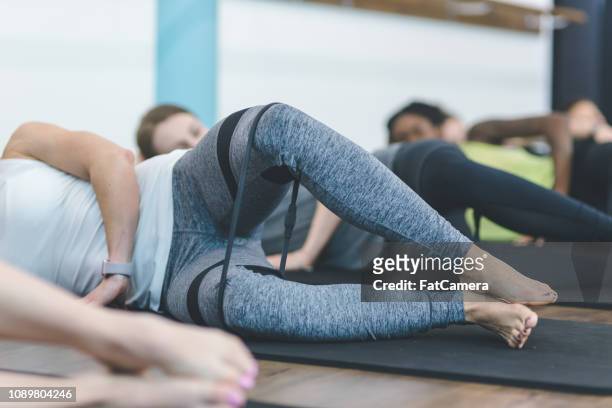 multiethnic group of women work out together in a modern health club - pike position stock pictures, royalty-free photos & images