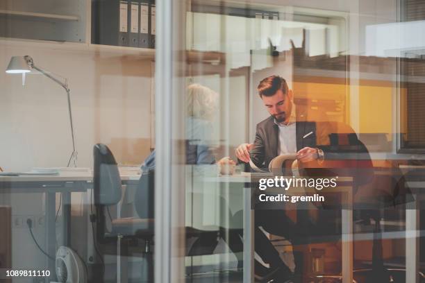 business couple working in the office - glass magazine stock pictures, royalty-free photos & images