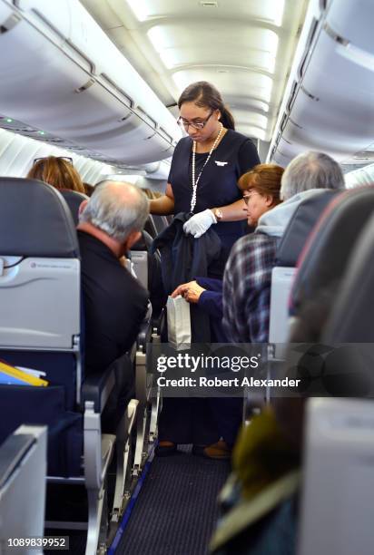 An American Airlines flight attendant assists a passenger who became airsick during a flight from San Antonio International Airport in Texas.