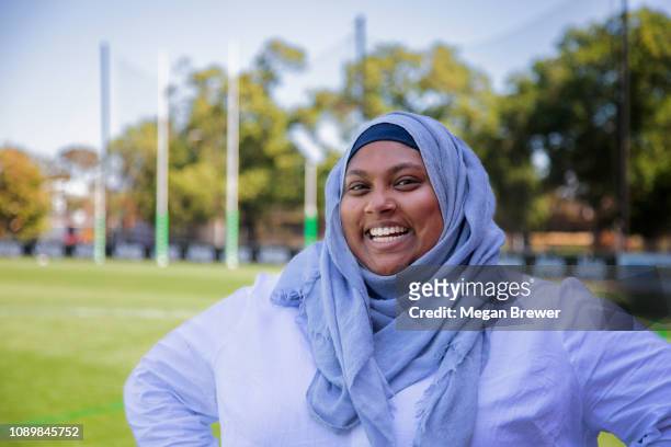 muslim woman on  footy oval - afl woman stock-fotos und bilder