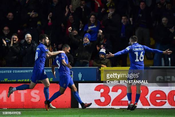 Wimbledon's Ghanaian striker Kwesi Appiah celebrates scoring the opening goal during the English FA Cup fourth round football match between AFC...