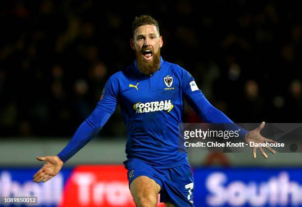 Scott Wagstaff of AFC Wimbledon celebrates scoring his teams second goal during the FA Cup 4th round match between AFC Wimbledon and West Ham United...