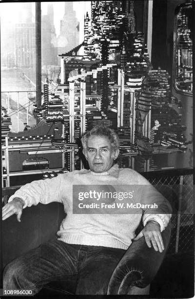 Portrait of American author Norman Mailer as he poses in front of a massive city built from Lego-brand building blocks in his home, New York, New...