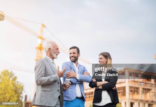 happy business people on a construction site. - property stock pictures, royalty-free photos & images