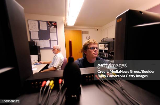 Library Media Services Coordinator Michael Riberdy, left, of the University of Colorado, creates a label for a newly made DVD while Eric Gehringer,...
