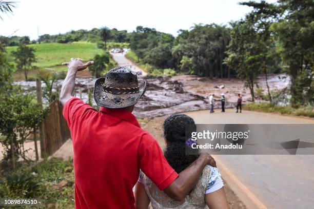 Man and a woman look at the scene after a tailings dam collapsed at an iron ore mine in Brumadinho, state of Minas Gerias, in southeastern Brazil, on...