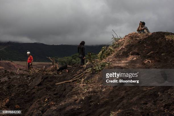 Residents and rescue workers survey damage after a Vale SA dam burst in Brumadinho, Minas Gerais state, Brazil, on Saturday, Jan. 26, 2019. A...