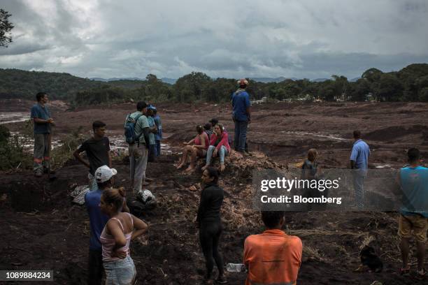 Residents and rescue workers survey damage after a Vale SA dam burst in Brumadinho, Minas Gerais state, Brazil, on Saturday, Jan. 26, 2019. A...