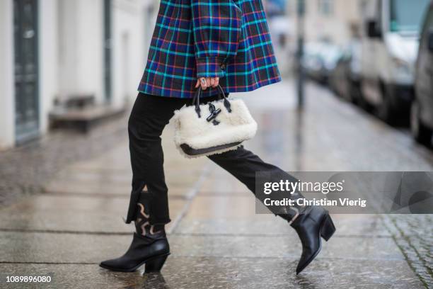 Swantje Soemmer is seen wearing blue checked Missoni jacket, black ripped denim jeans Boden, AGL cowboy boots and Longchamp bag on January 04, 2019...