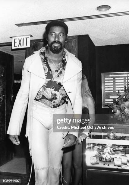 Basketball player Wilt Chamberlain is photographed at the Playboy Club circa 1973 in Los Angeles, California.