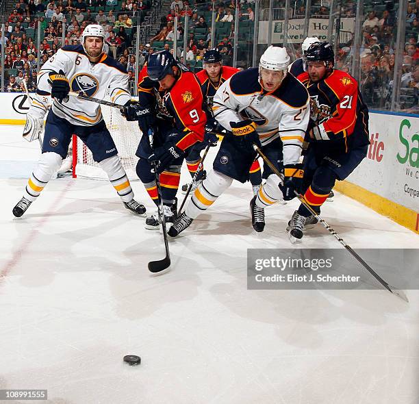 Stephen Weiss of the Florida Panthers tangles with Shaone Morrisonn of the Buffalo Sabres at the BankAtlantic Center on February 10, 2011 in Sunrise,...