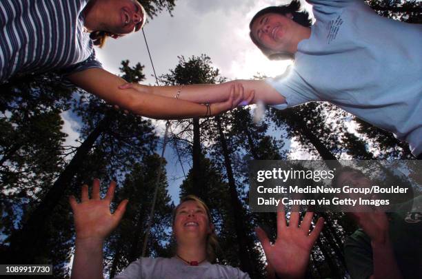 June 4, 2004 / Allenspark CO / Sara DeWaay left of Atlanta GA, and Lizzie Buchanan, right, balance agaist each other during a confidence course...