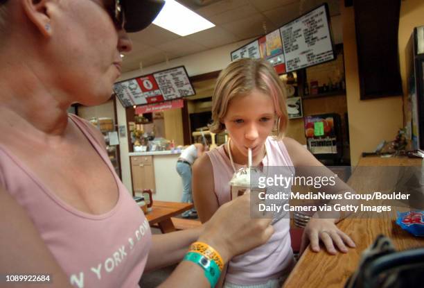 Kerri Gaffield and her daughter Amanda Polich from Phoenix Ar., enjoy a milk shake at the Lyons Soda Fountain in Lyons Colo., July 28, 2005.