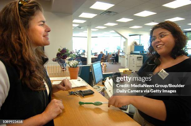 October 3, 2005 / Boulder Colo / Andrea Medina, right, with the Boulder Election Division, resisters Chris Ray of Ward on the last to resister to...