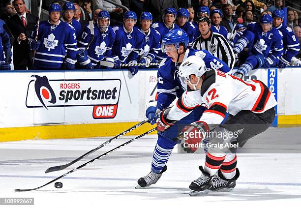 Tyler Bozak of the Toronto Maple Leafs battles for the puck with Brian Rolston of the New Jersey Devils during game action February 10, 2011 at the...