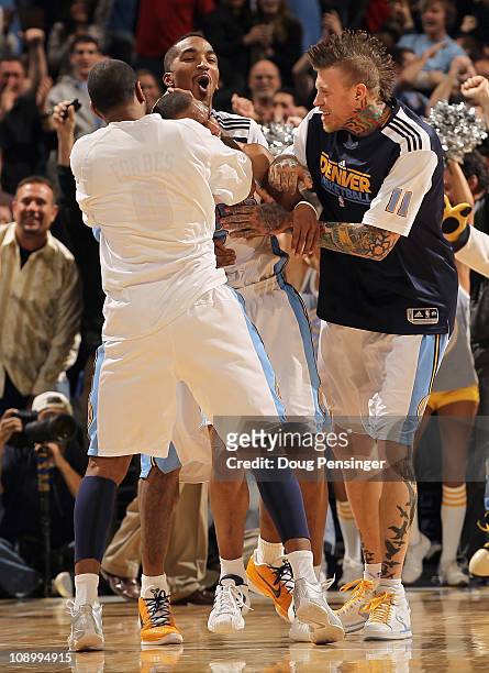 Arron Afflalo of the Denver Nuggets is congratulated by teammates Gary Forbes, J.R. Smith and Chris Andersen after he scored the game winning basket...