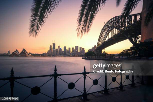 long exposure opera house with harbour bridge in sunset, sydney, australia - sydney harbour bridge night stock pictures, royalty-free photos & images