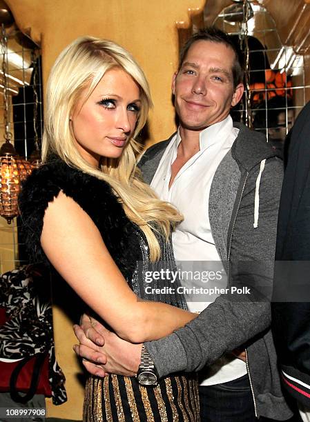Personality Paris Hilton and Cy Waits attend the RED launches with Usher after party on February 10, 2011 in Hollywood, California.