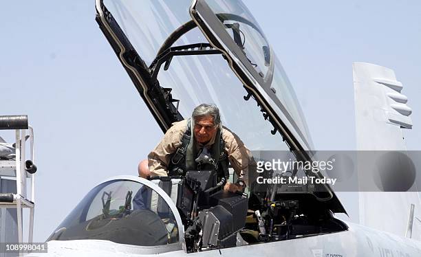 Tata Group Chairman Ratan Tata boarding a Boeing fighter F/A-18 Super Hornet at the Aero India 2011 at the Yelahanka air base on the outskirts of...