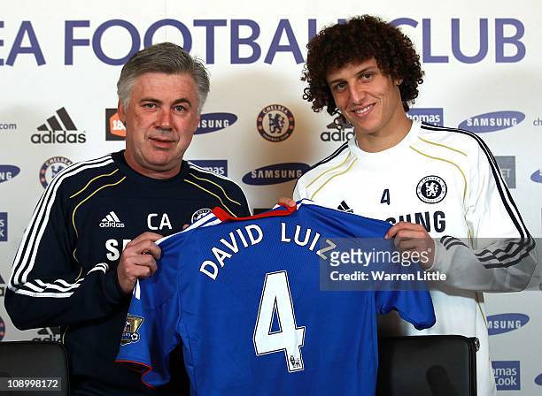 David Luiz of Chelsea is presented his shirt by Chelsea manager Carlo Ancelotti during a press conference at the Cobham training ground on February...