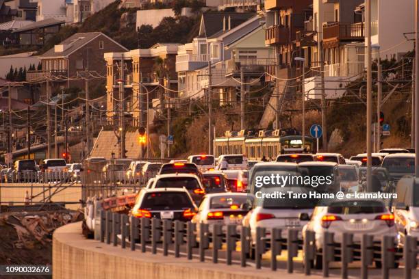 enoden, enoshima electric railway and heavy traffic coast road, route 134 in kamakura in japan - enoshima island stock pictures, royalty-free photos & images